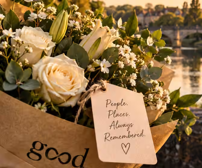 Illustrative cream flowers in kraft paper with a personal message card